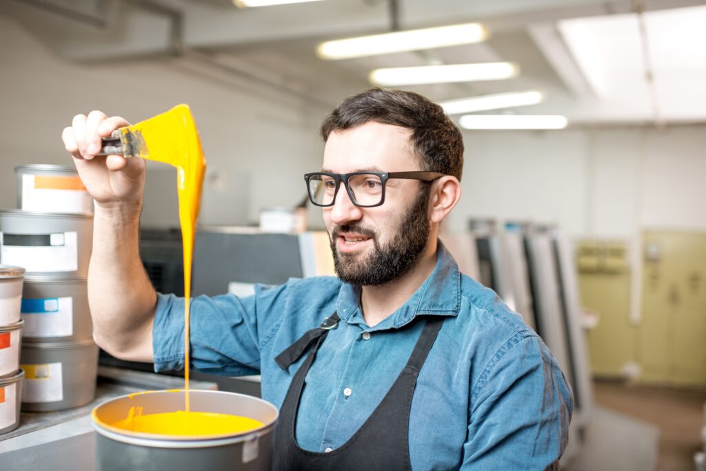 Typographer with paint at the manufacturing